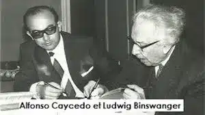 Photo en noir et blanc d’Alfonso Caycedo en conversation avec le professeur Ludwig Binswanger
